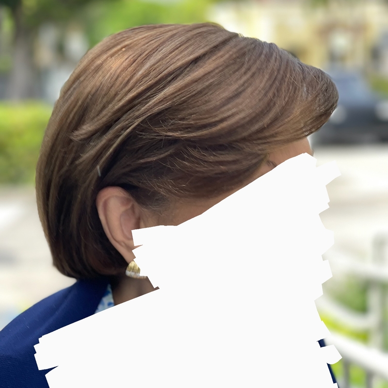 Short wig that can be pulled over the ear.